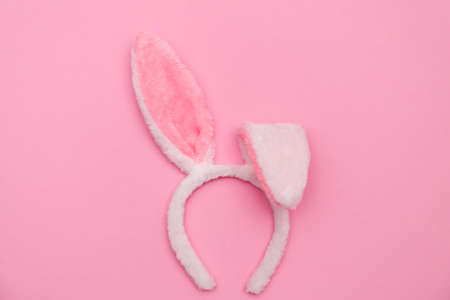 Easter bunny. Happy Easter holiday background concept.Flat lay colorful bunny egg with accessory to celebration on modern rustic pink pastel paper at home office desk.の写真素材