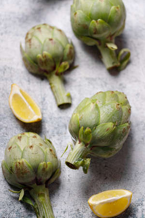 fresh artichokes on rustic gray backgroundの写真素材