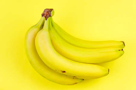 Top view and closeup of ripe yellow bunch of banansの写真素材