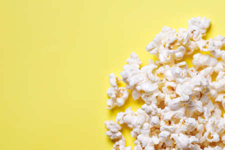 Home made popcorn on a yellow backgroundの写真素材