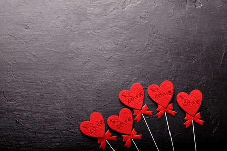 Beautiful valentines day background with red hearts on black background. Card for Valentine's Day. Love concept.の写真素材