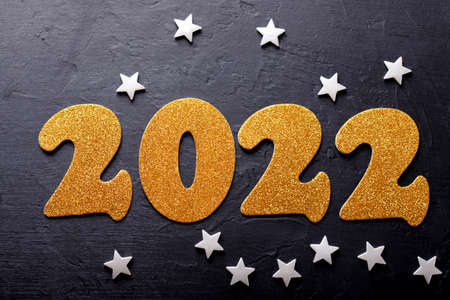 Merry Christmas and happy new year concept, 2022 golden numbers on black background