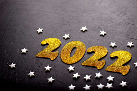 Merry Christmas and happy new year concept, 2022 golden numbers on black background