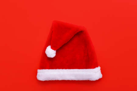 Santas hat on red christmas background with copy space for text.の写真素材