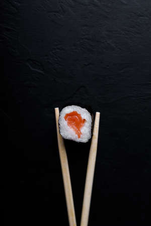 Sushi with tuna salmon rice and chopsticks on an isolated background.の写真素材