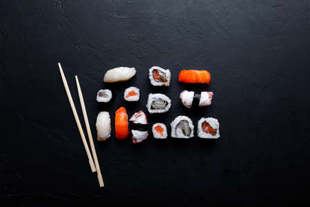 japanese sushi food. Maki ands rolls with tuna, salmon, shrimp, crab and avocado. Top view of assorted sushi.