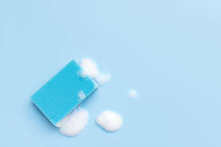 Multicolored sponges for cleaning on a blue background. Space for textの写真素材