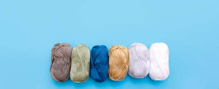 Skeins of wool yarn and knitting needles.