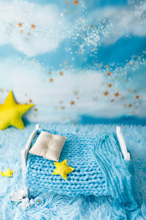 Blue newborn digital backdrop with stars and moon on a colourful backgroundの写真素材