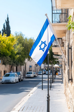 Israeli Flag Displayed on Historic Stone Street with Potted Plantsの素材