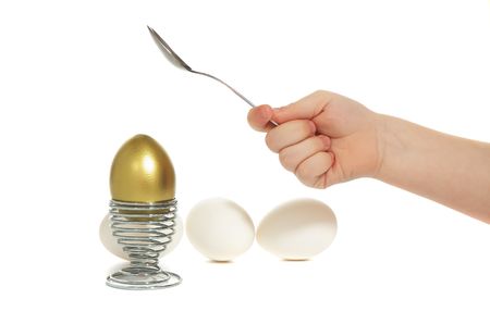 nursery hand broken golden egg on iron stand near by white egg isolated on white backgroundの写真素材