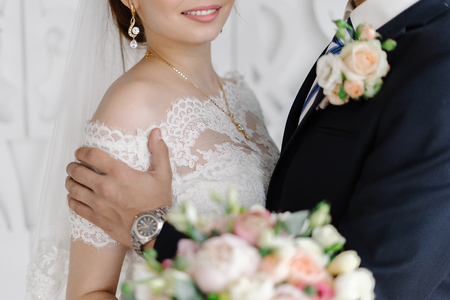 Groom gently hugging smiling brideの写真素材