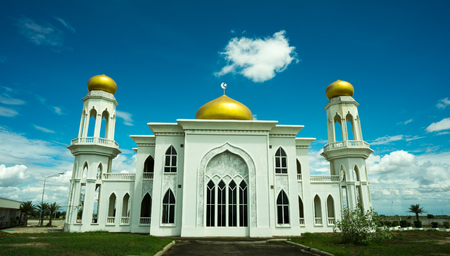 the big white place of worship of Muslim with gold roof on topの写真素材
