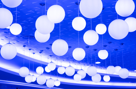 a big group of circle light bulbs on the blue background.の写真素材