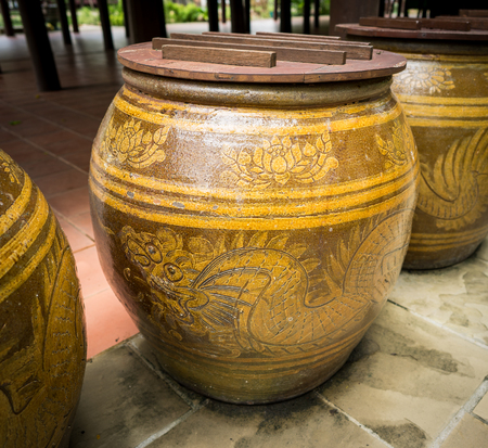 a big earthen jar made from clay with dragon pattern on sideの写真素材