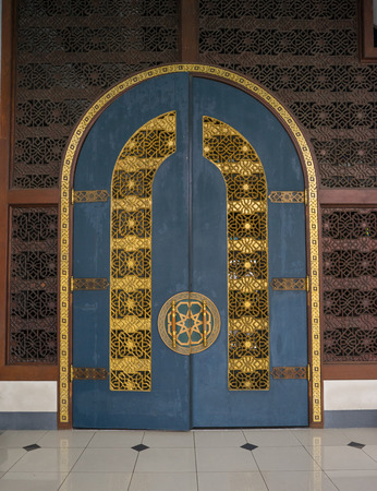 the very big wooden door inside of the biggest mosque in Indonesiaの写真素材