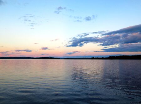 A calm lake in the north of Sweden in the midsummer nightの写真素材