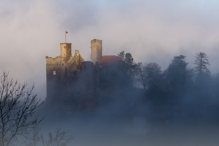 Castle ruin - ancient castle in morning fogの写真素材