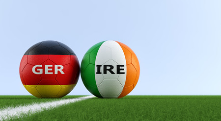 Ireland vs. Germany Soccer Match - Soccer balls in Irish and Germanys national colors on a soccer field. Copy space on the right side - 3D Renderingの写真素材