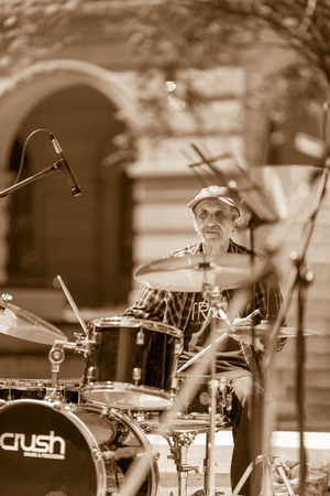 DIMITROVGRAD, BULGARIA - APRIL 30, 2018: Experienced jazz player performs complex drum music at street concert event dedicated to International World Jazz Day. Isolated viewのeditorial素材