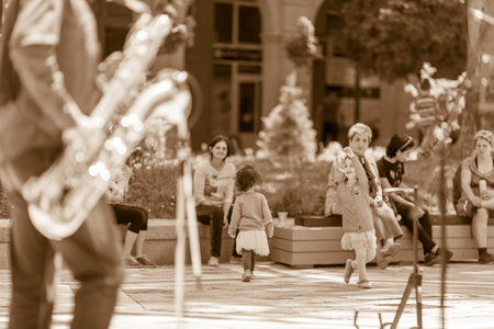 DIMITROVGRAD, BULGARIA - APRIL 30, 2018: Two children dancing full of joy at street concert event dedicated to International World Jazz Dayのeditorial素材