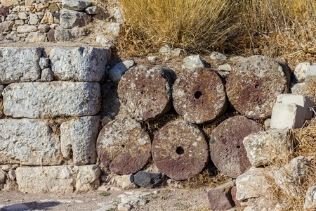 Ancient stone masonry and round volcanic stone ruins and remainings, Santorini, Greeceの写真素材