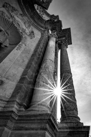 VALENCIA, SPAIN - FEBRUARY 18, 2013: Spring Sun diffracts beautifully between ancient carved columns near the Cathedral and ray of lights pass through them. Black and white imageのeditorial素材