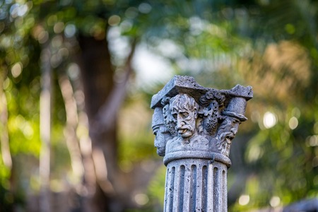 DUBROVNIK, CROATIA - DECEMBER 30, 2014: Beautiful ancient chapitel or column capital is kept as decoration in garden yard of the University of Dubrovnik. Winter sunny day photo with blurred backgroundのeditorial素材