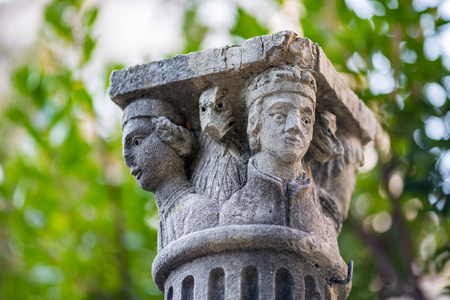DUBROVNIK, CROATIA - DECEMBER 30, 2014: Beautiful ancient chapitel or column capital is kept as decoration in garden yard of the University of Dubrovnik. Winter sunny day photo with blurred backgroundのeditorial素材