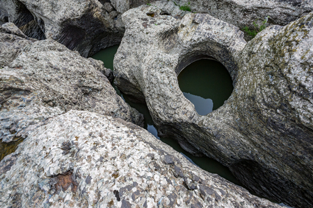 Daytime spring view taken at the amazing Devil's Canyon natural phenomenon in Bulgaria, also known as Sheytan Dere near Studen Kladenetz reservoir in Rhodope Mountain. Wonderful green watersの写真素材