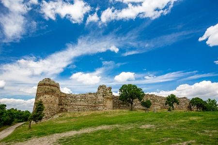 Colorful cloudy sky springtime landscape with the remains of ancient Roman fortress, Rhodope...