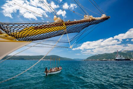 TIVAT, MONTENGRO - MAY 16, 2017: Group of young sporty people sailing training under bow of vintage...