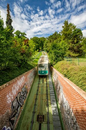 PRAGUE, CZECH REPUBLIC - AUGUST 28, 2015: Funicular transports tourists to station near the Petrin observation and lookup tower in the Petrin park in West Prague, Czech Republic in overcast summer dayのeditorial素材