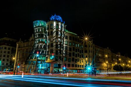 PRAGUE, CZECH REPUBLIC - AUGUST 28, 2015: Famous Dancing House is illuminated with bright lights during nights, Prague, capital of Czech Republic in summer. Motion blur lines from the road trafficのeditorial素材