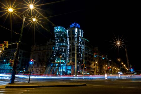PRAGUE, CZECH REPUBLIC - AUGUST 28, 2015: Famous Dancing House is illuminated with bright lights during nights, Prague, capital of Czech Republic in summer. Motion blur lines from the road trafficのeditorial素材