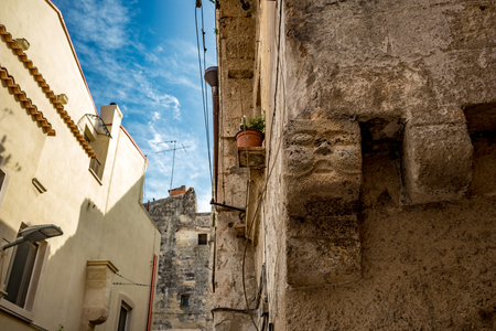 Square head architectural detail from the historic center of Altamura, Italy, Puglia region, street view, scenery summer day with puffy white cloudsの写真素材