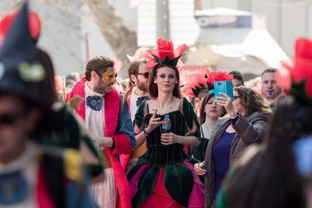 XANTHI, GREECE - MARCH 10, 2019: Masquerade participants march and have fun in colorful costumes. Small and big groups of Greek people parade annually on city streets in thematic festival outfitsのeditorial素材