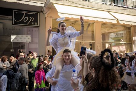 XANTHI, GREECE - MARCH 10, 2019: Masquerade participants march and have fun in colorful costumes....