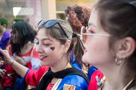 XANTHI, GREECE - MARCH 10, 2019: Masquerade participants march and have fun in colorful costumes. Small and big groups of Greek people parade annually on city streets in thematic festival outfitsのeditorial素材