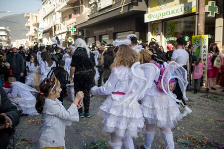 XANTHI, GREECE - MARCH 10, 2019: Masquerade participants march and have fun in colorful costumes. Small and big groups of Greek people parade annually on city streets in thematic festival outfitsのeditorial素材