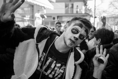 XANTHI, GREECE - MARCH 10, 2019: Masquerade participants march and have fun in colorful costumes....