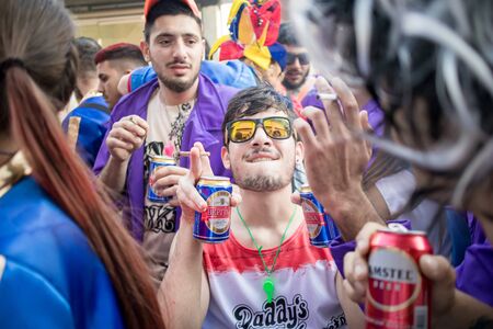 XANTHI, GREECE - MARCH 10, 2019: Masquerade participants march and have fun in colorful costumes. Small and big groups of Greek people parade annually on city streets in thematic festival outfitsのeditorial素材