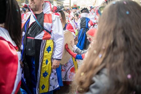 XANTHI, GREECE - MARCH 10, 2019: Masquerade participants march and have fun in colorful costumes....