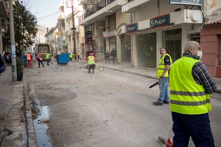 XANTHI, GREECE - MARCH 10, 2019: Cleaners take care of the colorful garbage right after parade of famous Greek carnival where people participate annually on city streets in thematic festival outfitsのeditorial素材