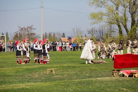 VARVARA, BULGARIA - MARCH 24, 2019: Moment from National Festival Dervish Varvara presents traditions of Bulgarian Kuker Games. Performers present their folklore play to the audience on local stadiumのeditorial素材