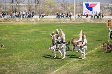 VARVARA, BULGARIA - MARCH 24, 2019: Moment from National Festival Dervish Varvara presents traditions of Bulgarian Kuker Games. Performers present their folklore play to the audience on local stadiumのeditorial素材