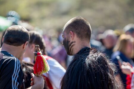 VARVARA, BULGARIA - MARCH 24, 2019: Moment from National Festival Dervish Varvara presents traditions of Bulgarian Kuker Games. Man with face covered in black talks to his friend after the showのeditorial素材