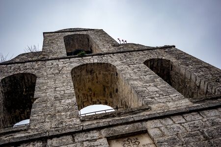 Street view of the Holy Church of Dormition of the Virgin Mary, Ioannina island on lake Pamvotida near the beautiful small island near the Greek town of Ioannina. Early morning dark spring day sceneの写真素材