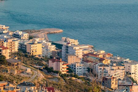 Sunset elevated view taken in the golden hour of a calm spring evening, Saranda, Albania, residential quarterの写真素材