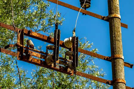 Old rusty electric equipment with clear blue sky and green blurred forest background near the Blue Eye water source in Albania. Sunny spring dayの写真素材